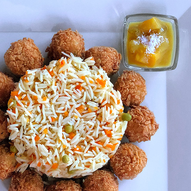 Fish Balls rolled in Cornflakes and served with Basmati Rice and Curry Sauce